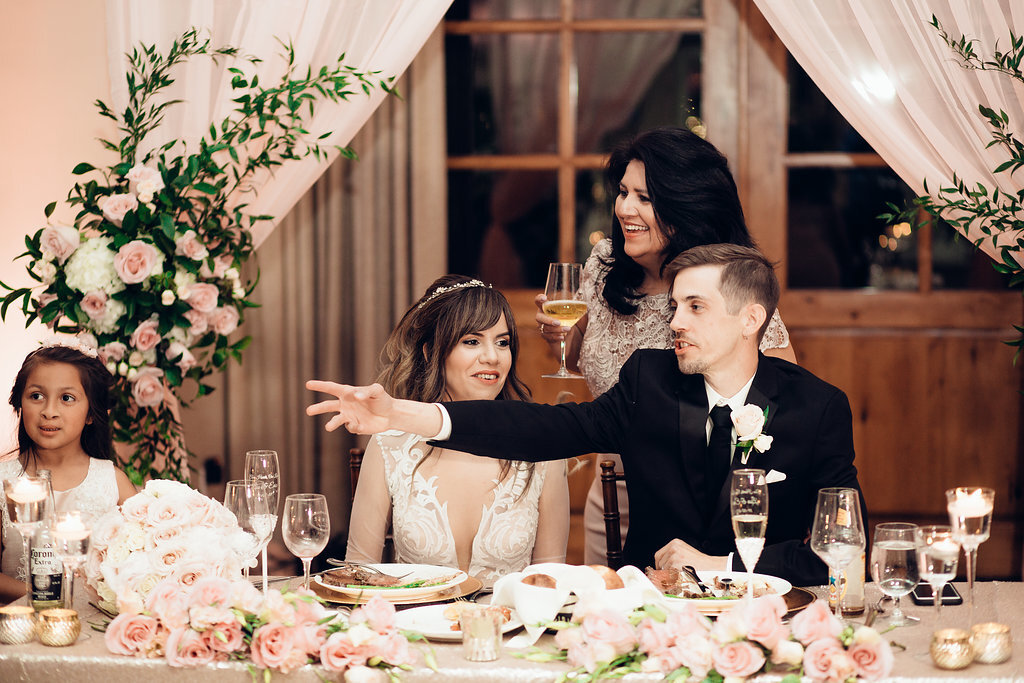 Wedding Photograph Of Groom raising His Hand Beside His Bride Los Angeles