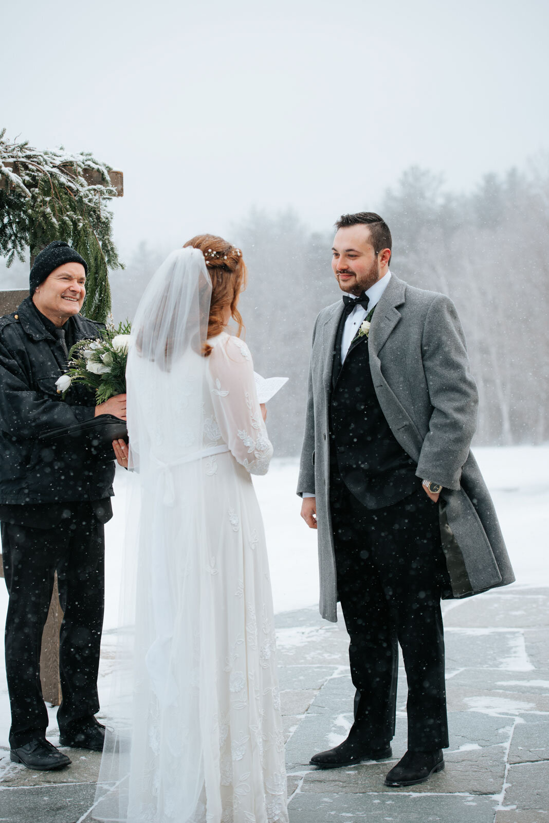 winter elopement reading vows on patio at mountain top inn