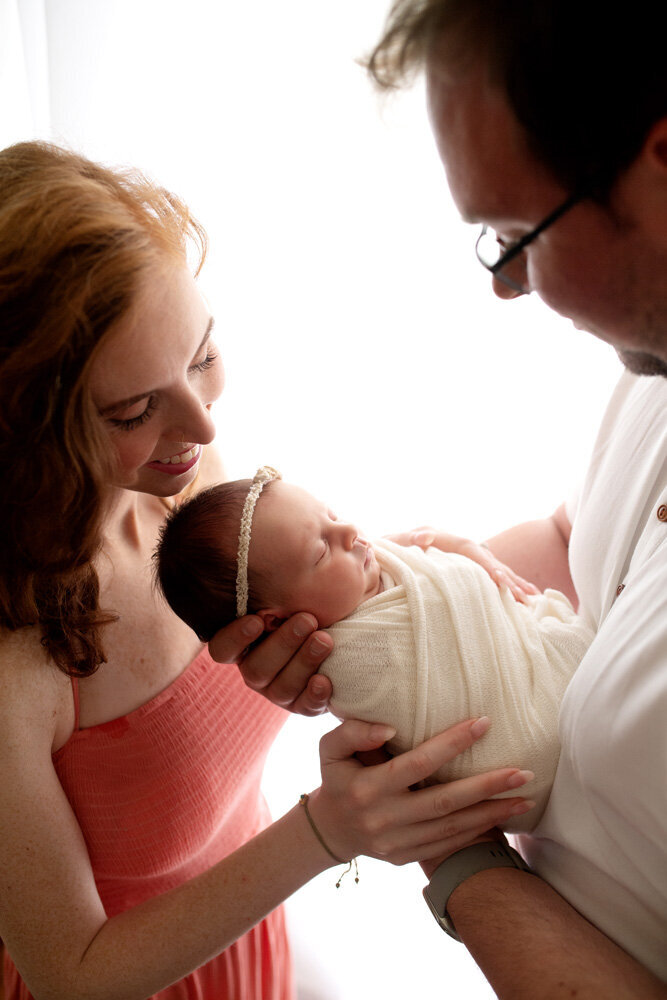 Newborn session of baby girl wearing a bow