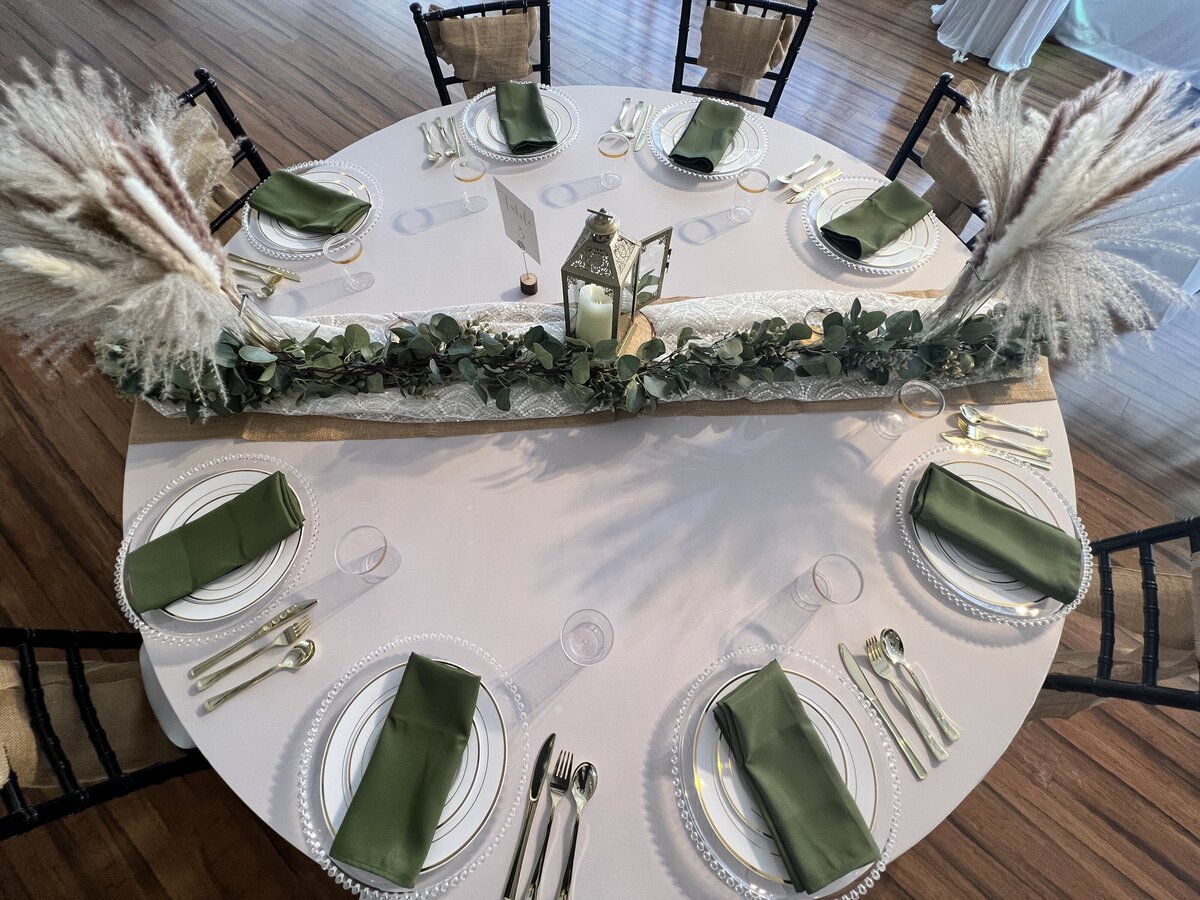 Guest table showcasing our inclusive decor package with rustic chic boho centerpieces and a simple design - Perfect for your Clearwater celebration