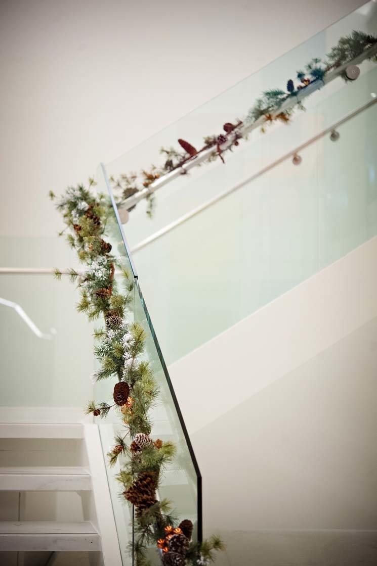greenery garlands of stair railing at Seattle holiday party decor