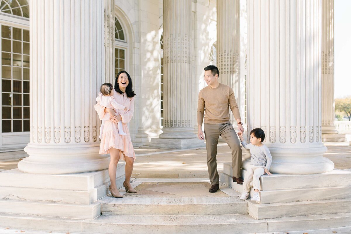 family with young children standing beside columns in washington dc