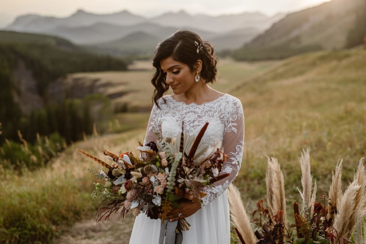 Bride wearing stunning two piece lace bridal gown from Cameo & Cufflinks, a contemporary bridal boutique based in Calgary, Alberta. Featured on the Brontë Bride Vendor Guide.