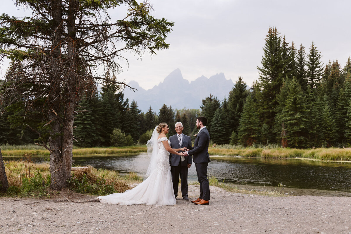 a couple exchanging their vows in front of the Grand Teton National Park