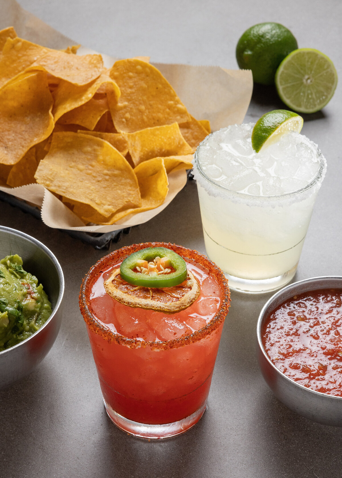 Cocktails next to chips, salsa, and guacamole