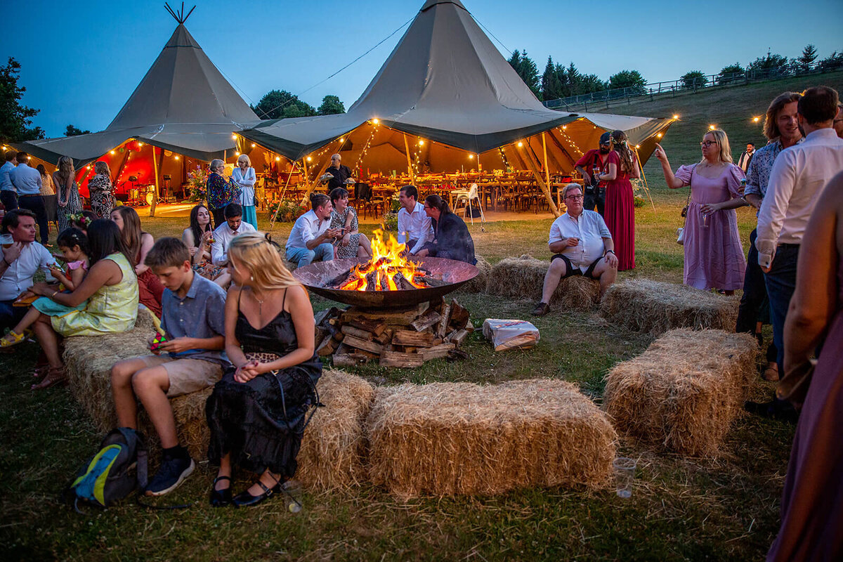 Night time shot of guests gathered around  bonfire at Green hill Farm Wedding