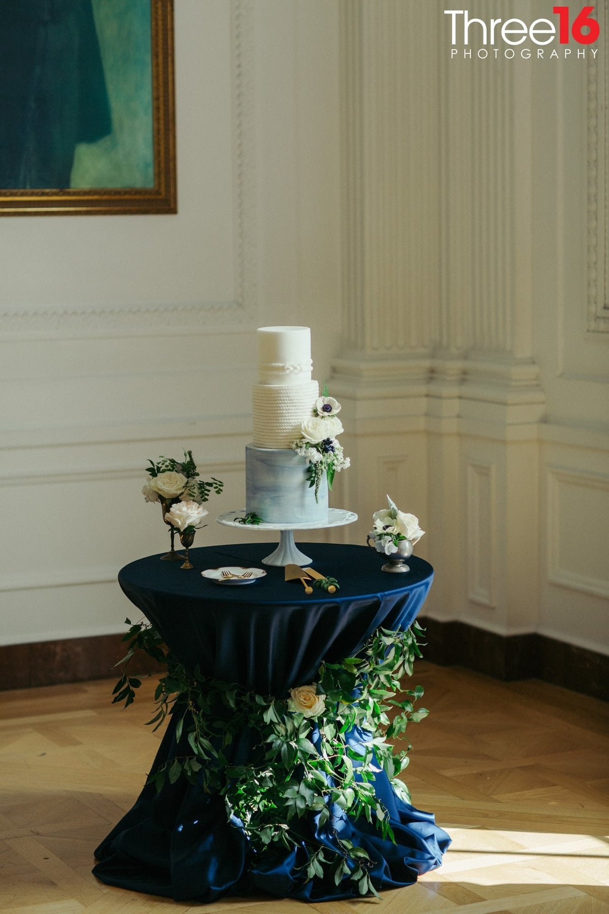 Beautiful 3-tiered white and blueish wedding cake