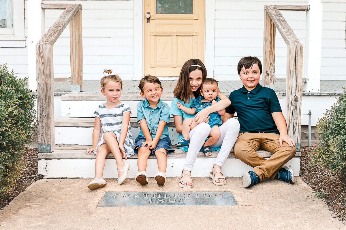 Cousins on steps of historic house