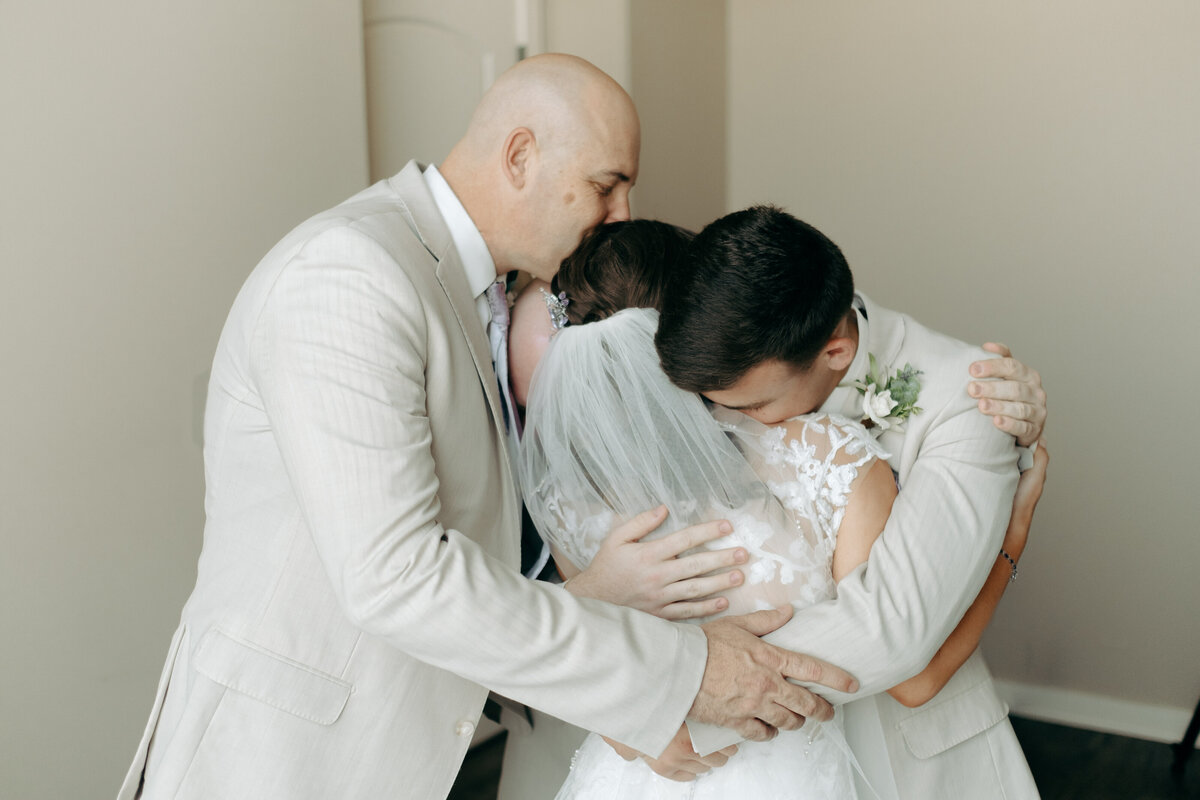 Bride hugging people she loves St Catherine of Siena Wedding  | The Axmanns
