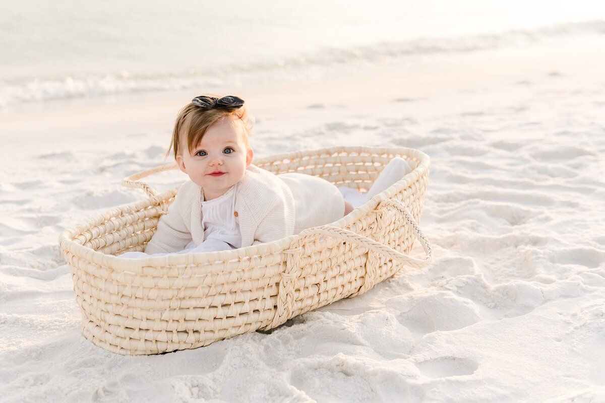 kid in a moses basket photographed by destin family photographer