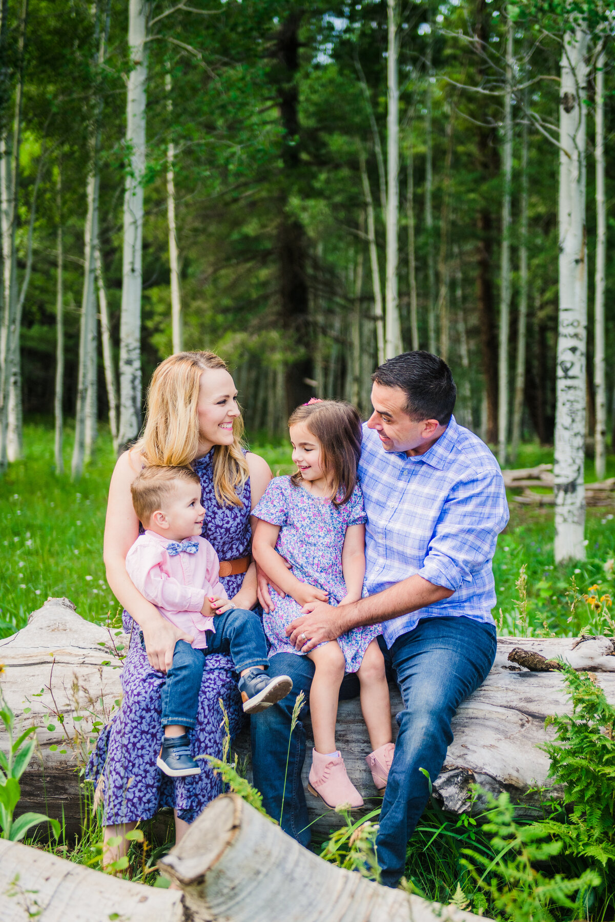 Family in aspens summer green smiling Flagstaff Arizona Snowbowl