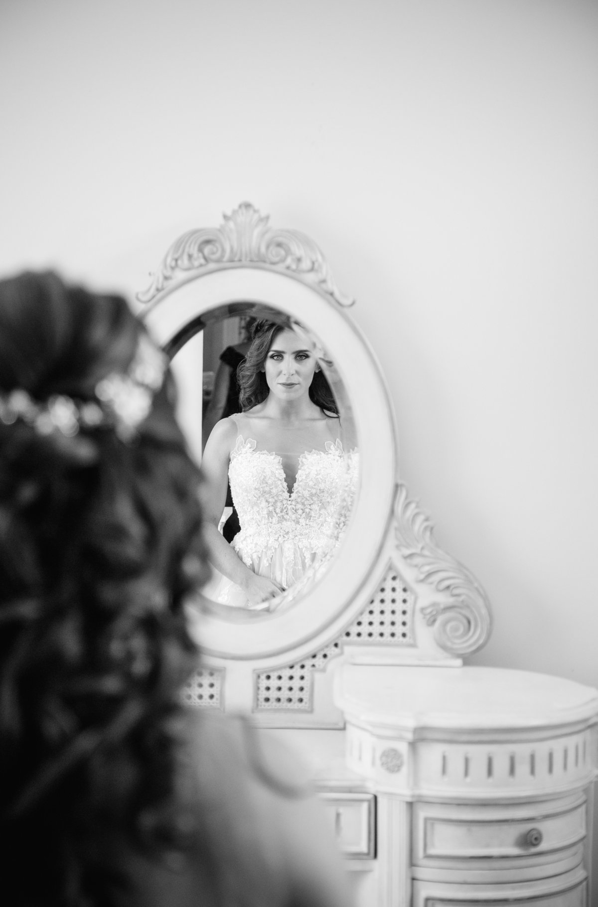 bride looking in mirror before wedding at shadowbrook at shrewsbury