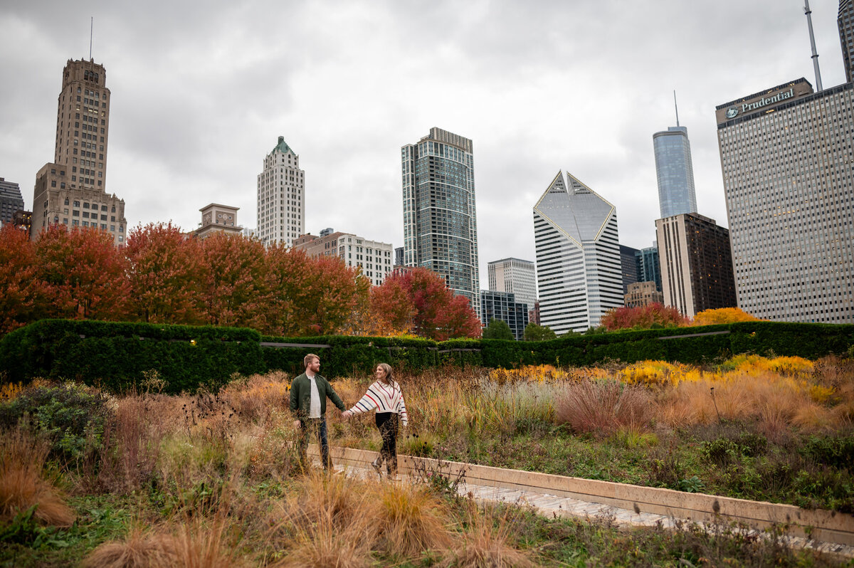 A couple walk in Maggie Daley Park in Fall.
