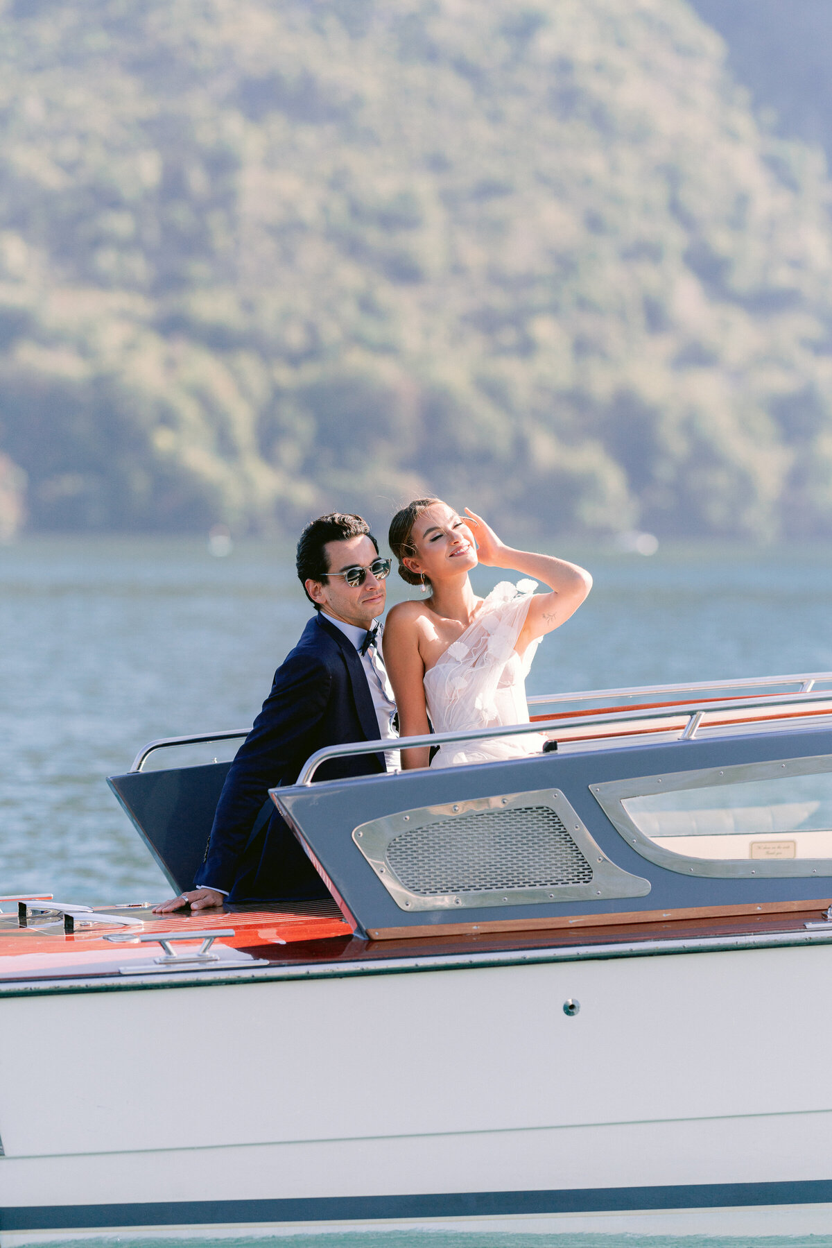 Bride and groom on a private boat in Lake Como, by destination wedding photographer, White Orchid Photography