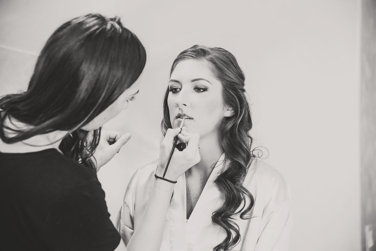 bride getting ready with makeup artist