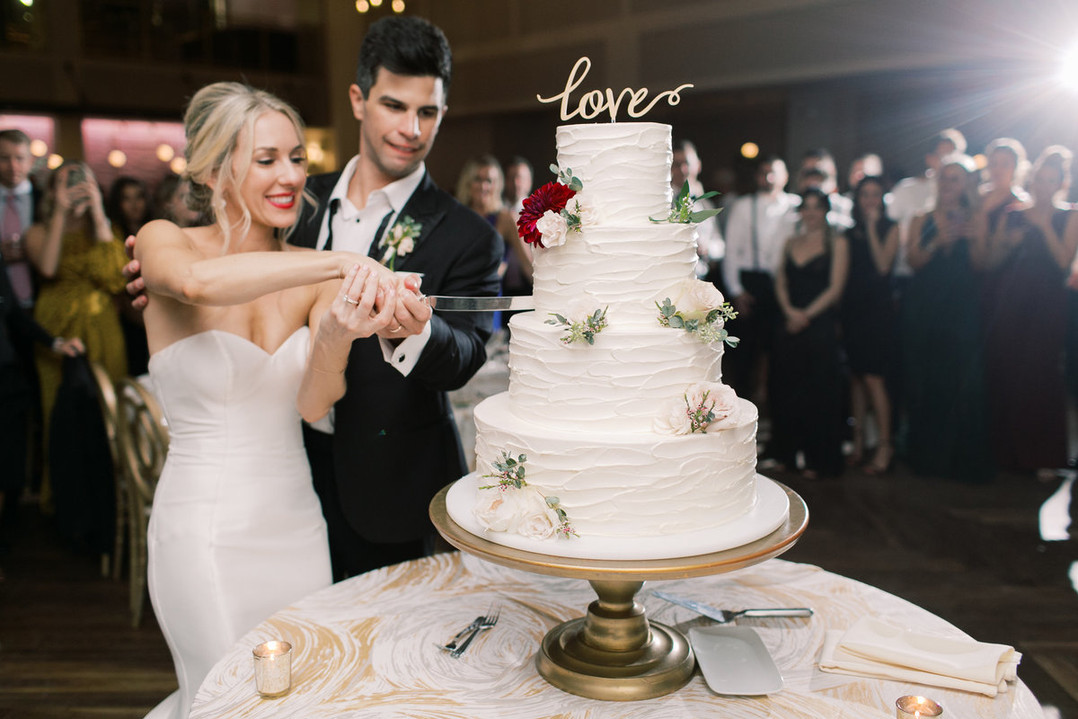bride and groom cutting cake at philadelphia wedding reception