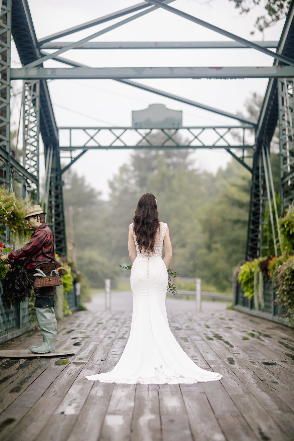 bride on bridge with flowers at riverview  wedding