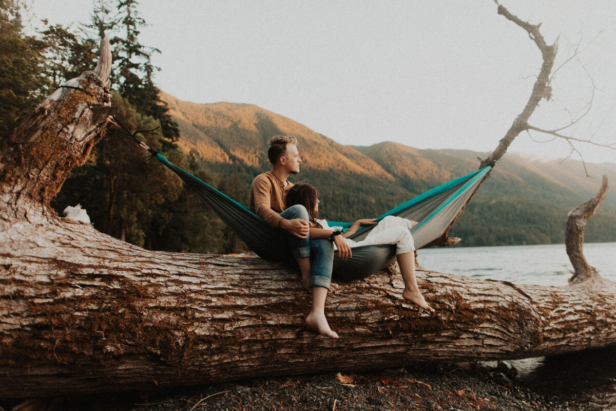 Madi and Tristan Jeno sitting in a hammock overlooking a lake