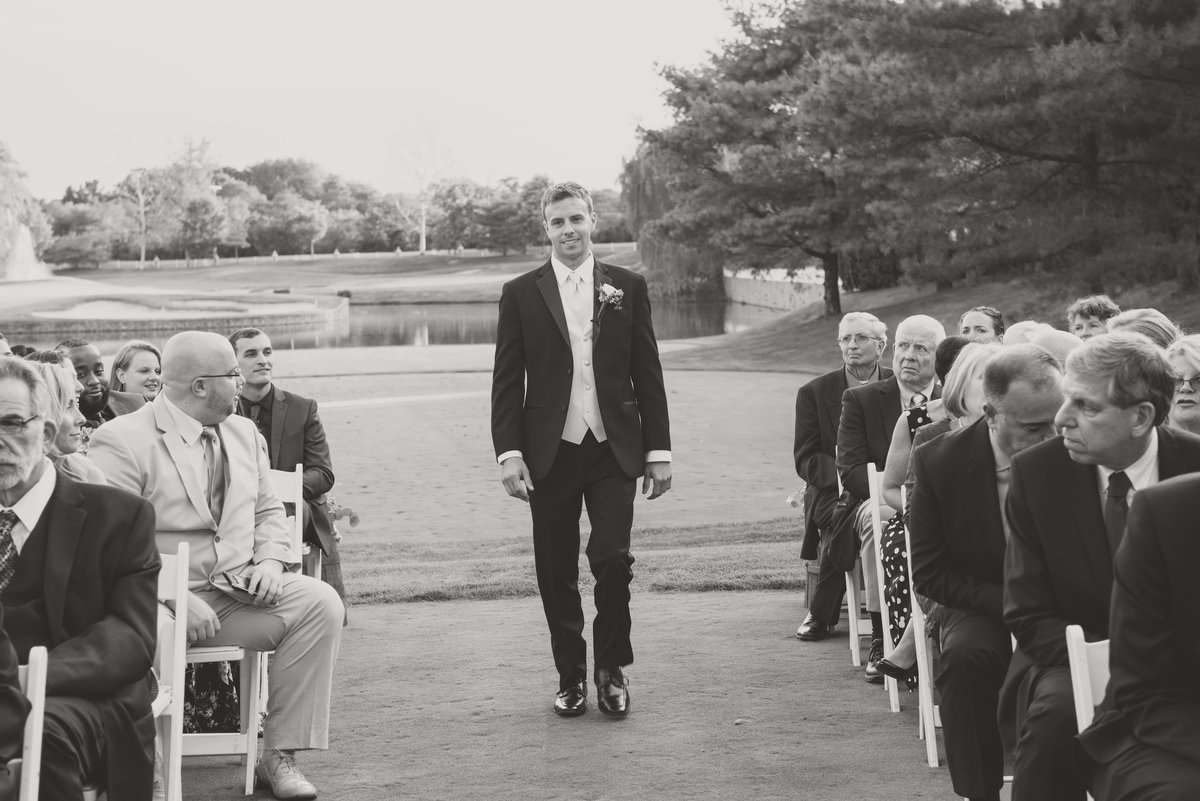 black and white groom walking down the aisle wedding photo at Willow Creek Golf and Country Club