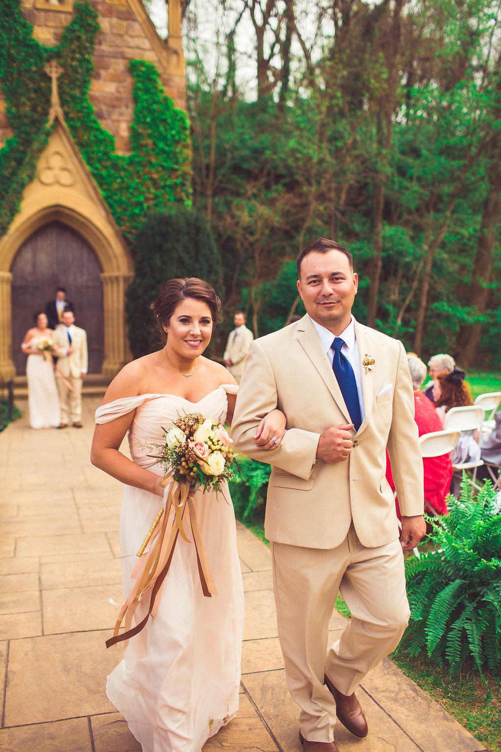Wedding Photograph Of Bridesmaid in Peach Dress and Man in Light Brown Suit Walking Down The Aisle Los Angeles