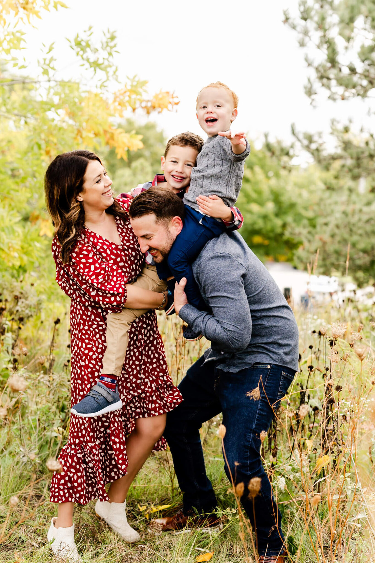 Fun and playful photo of family with kid on dad's shoulders during their family session at Eldridge Park.