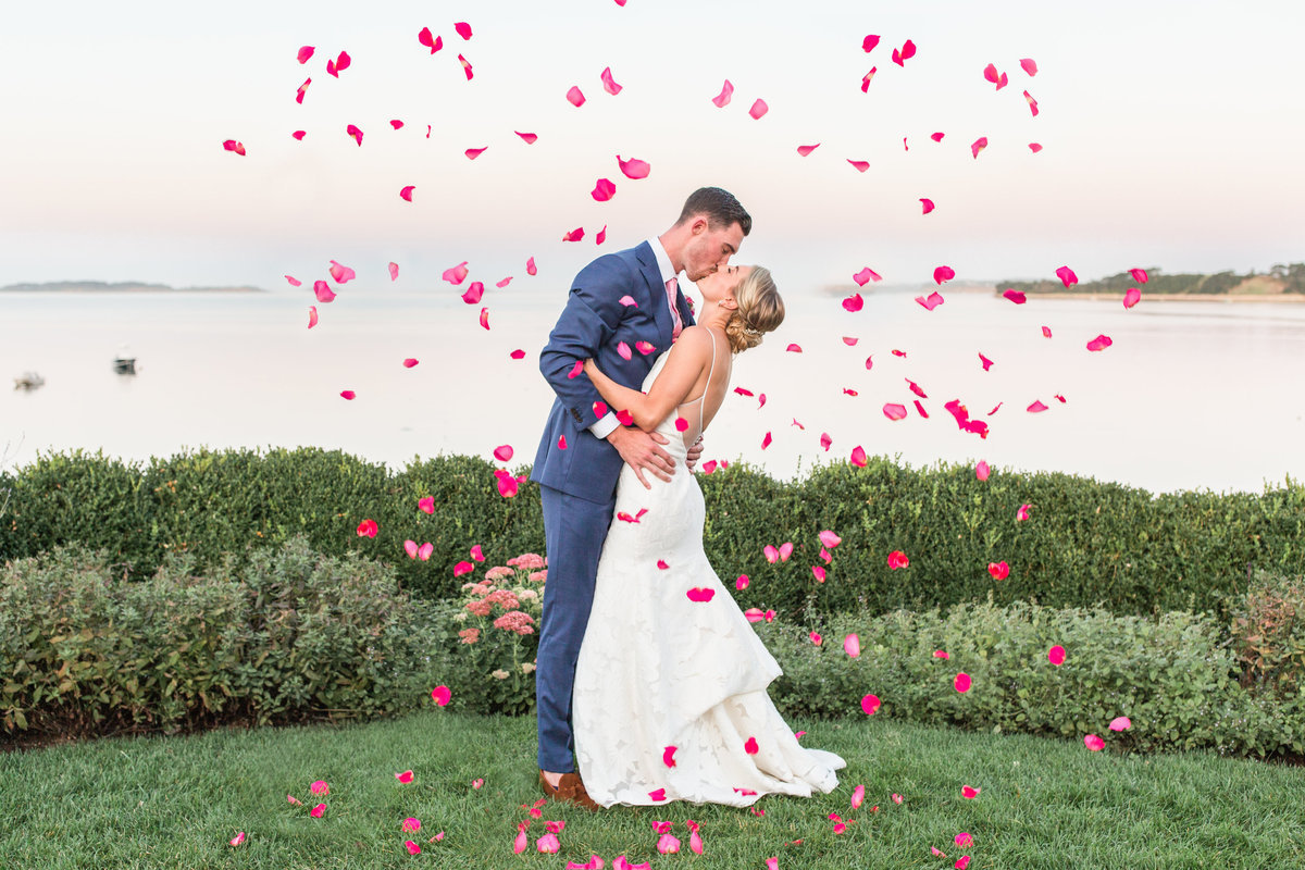 Couple kissing with flower petals at Wequassett