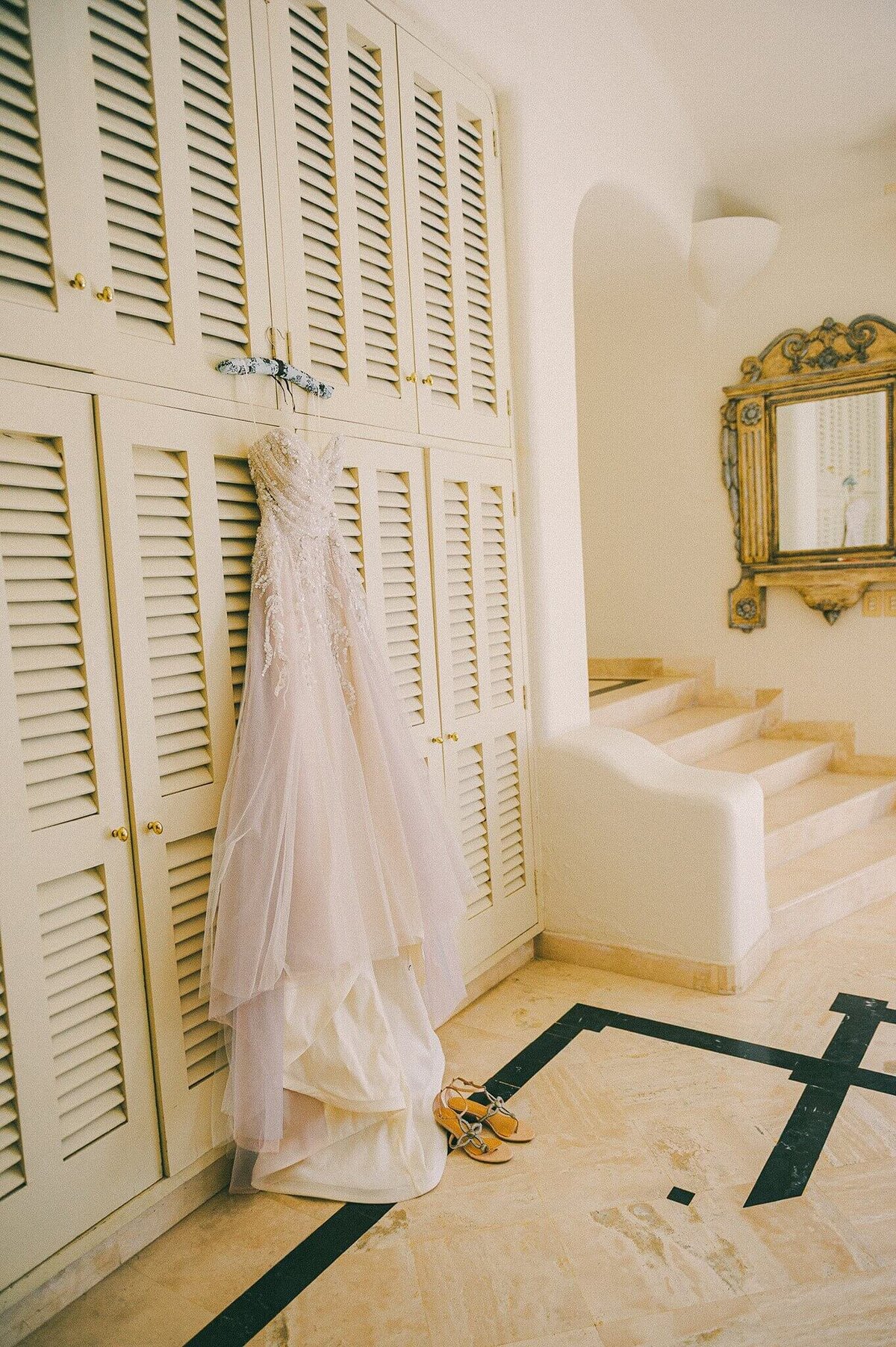 Blush wedding dress hangin with shoes in Sayulita mexico wedding