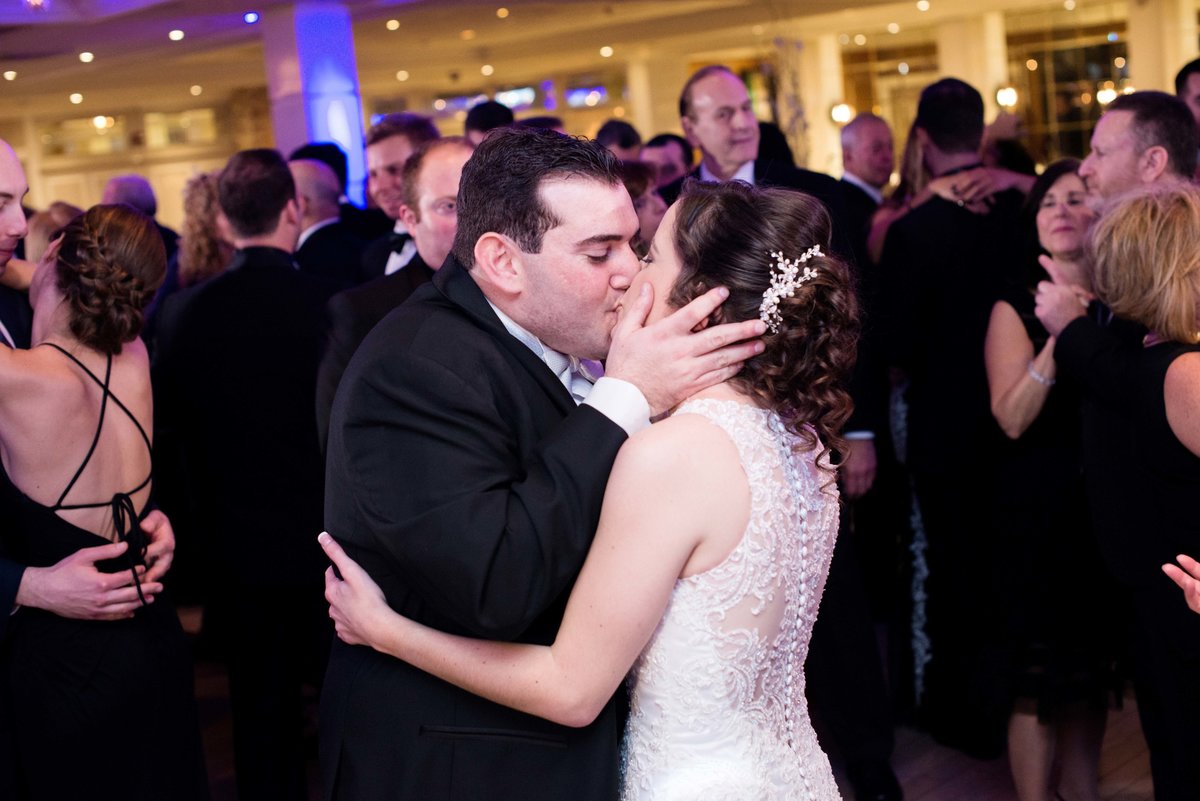 Bride and groom kissing on the dancefloor at Watermill Caterers