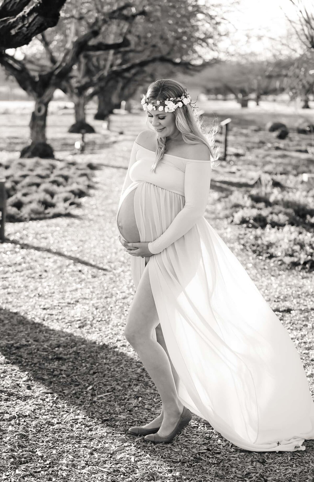 maternity photographer in Wake Forest, NC. Mother to be smiling at her belly.