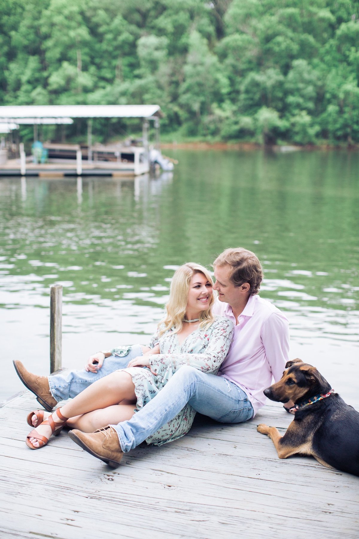 Wedding Photographer, couple sitting on dock with their dog