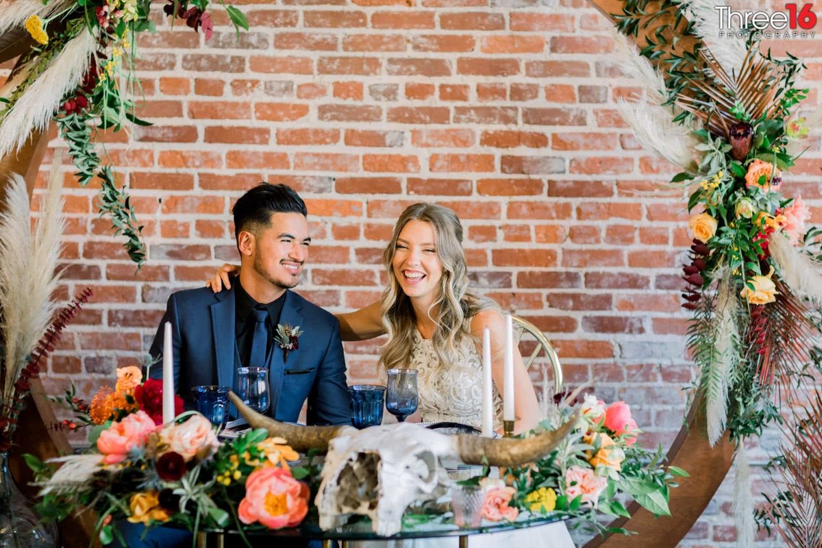 Bride and Groom share a laugh as they sit to relax