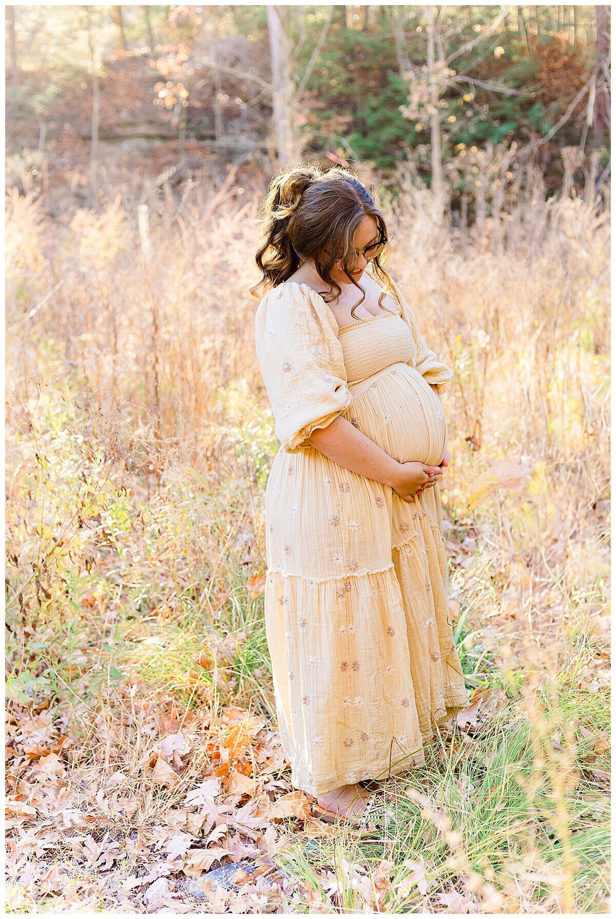an outdoor Maternity Photography in Wexford where it is golden hour and mom to be looks stunning and looking at her baby belly