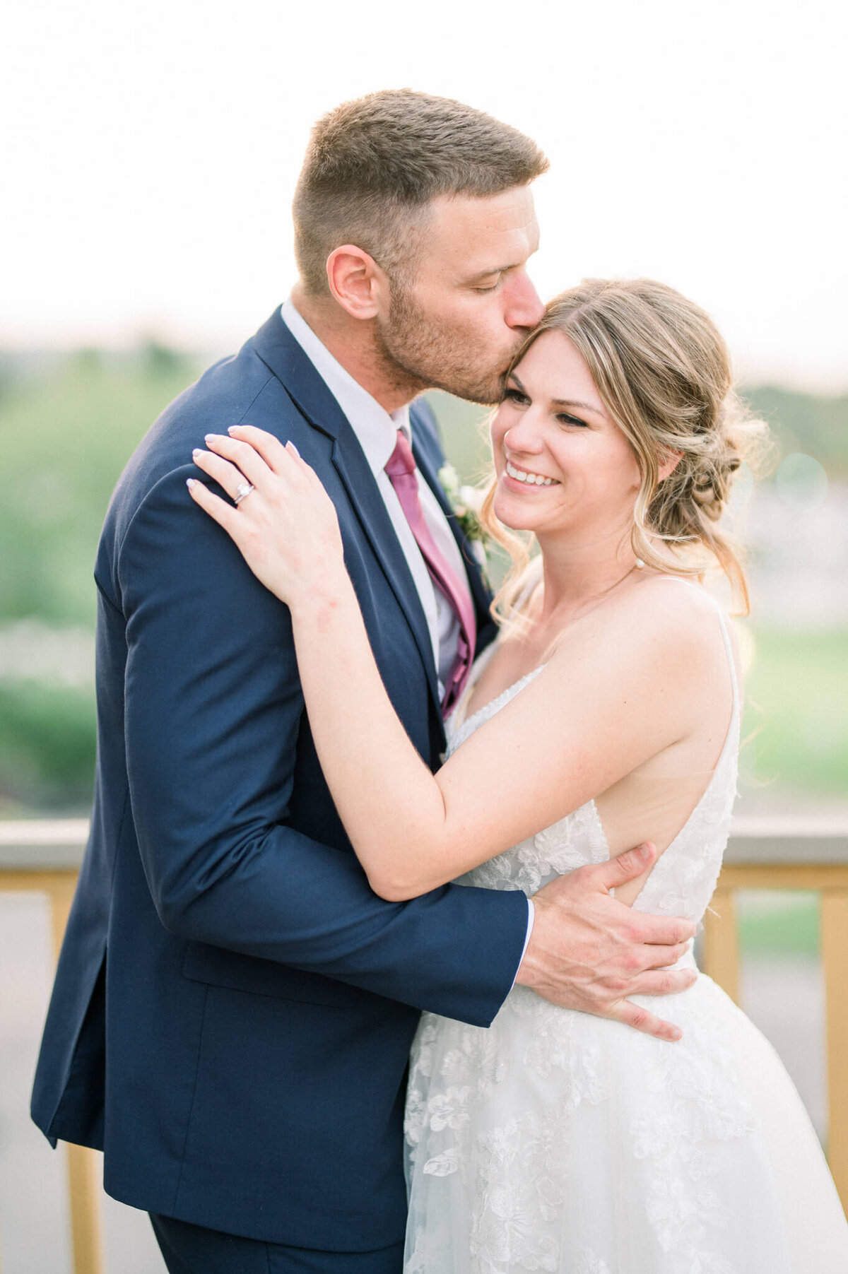 Groom kisses brides forehead for their Toronto wedding photographer