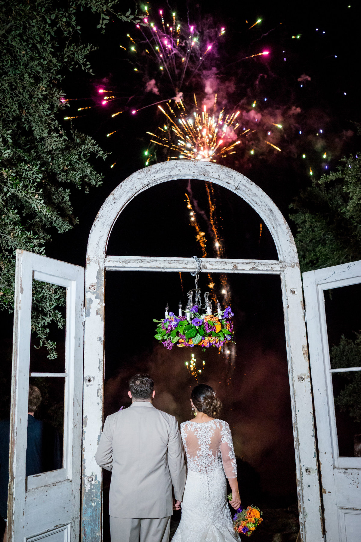 Bride and groom watch fireworks from outdoor altar wedding ceremony site for grand exit at Marquardt Ranch venue hill country