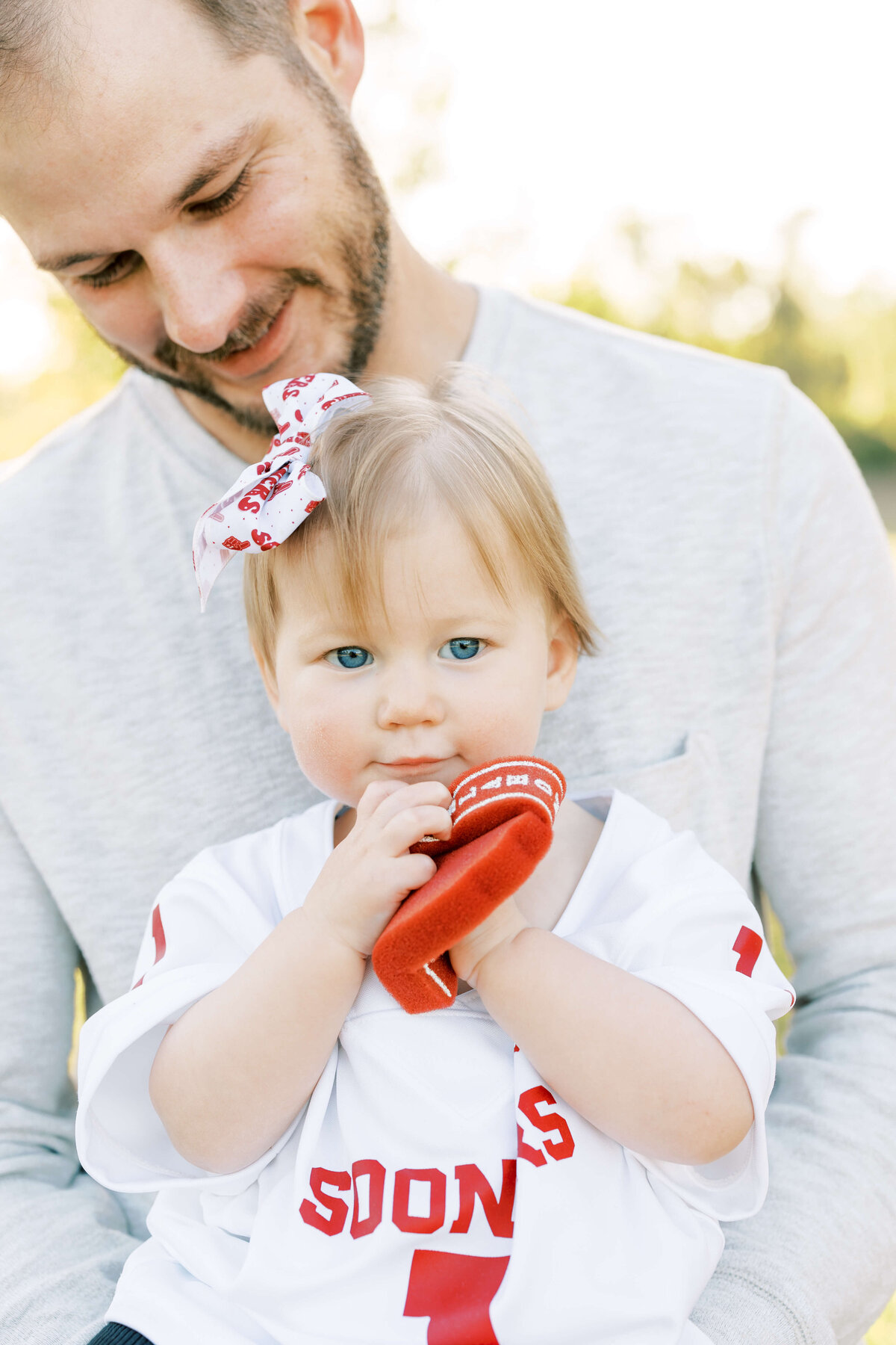 a little girl sitting in her dad's lap