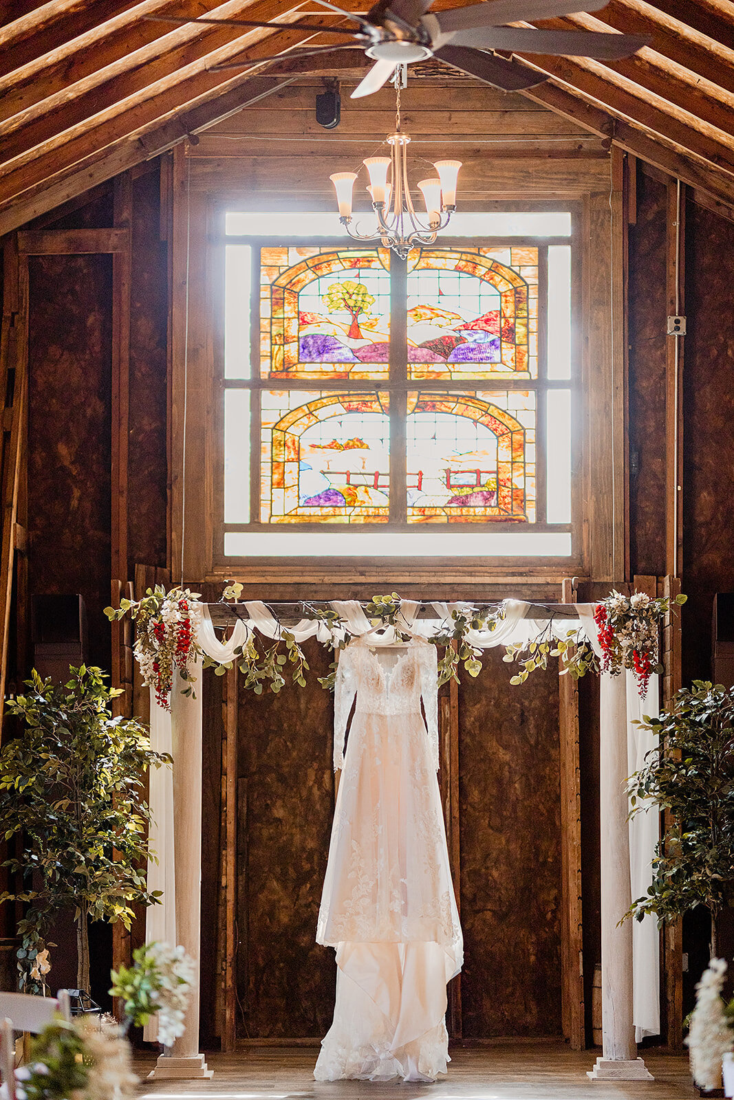wedding dress hanging from the alter