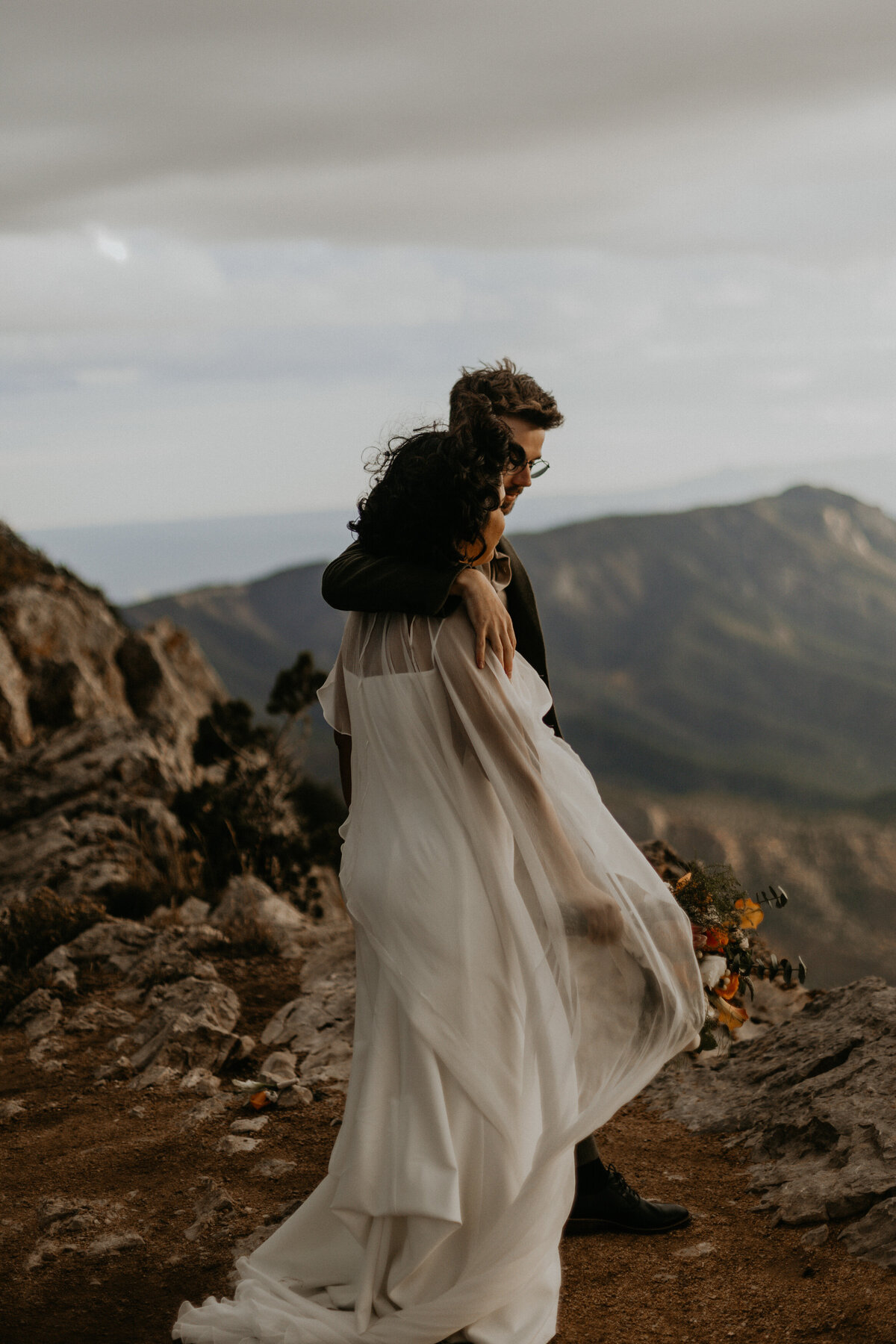 Bride and groom on sandia mountain peak