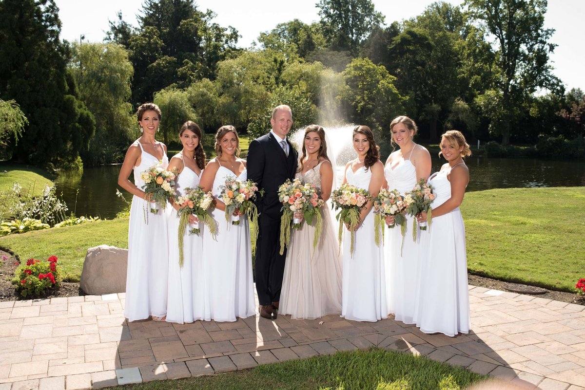 Bride and groom with bridesmaids outside at Flowerfield