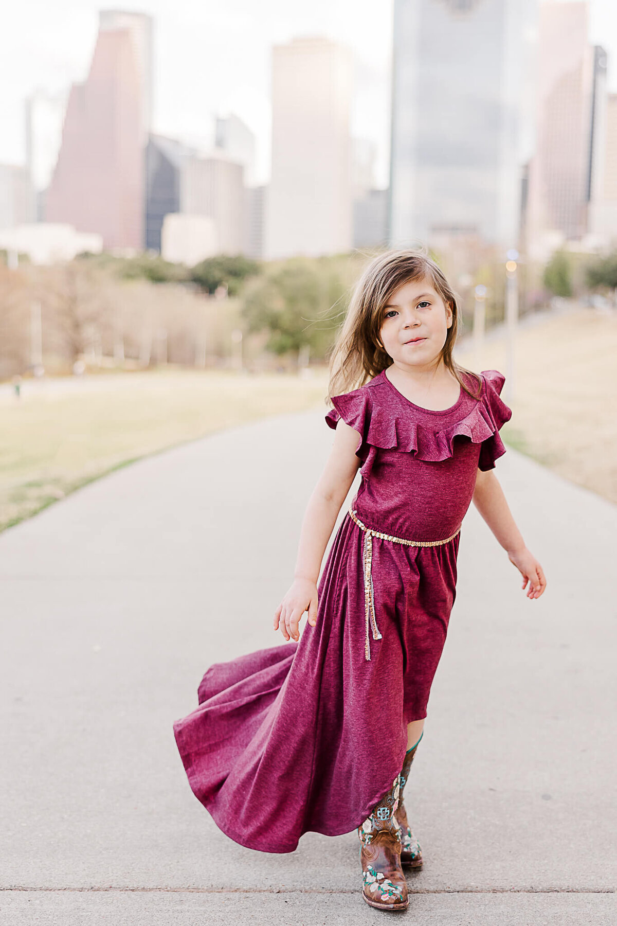 Young girl walking with purple dress on