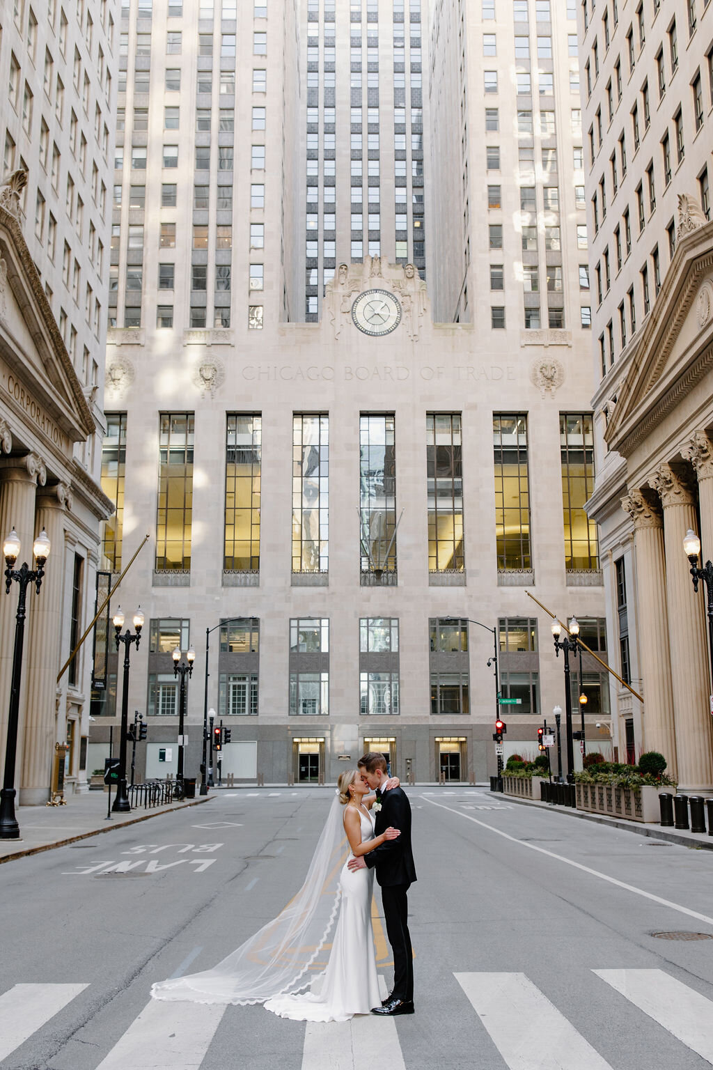 Bride and groom kiss on street in downtown Chicago