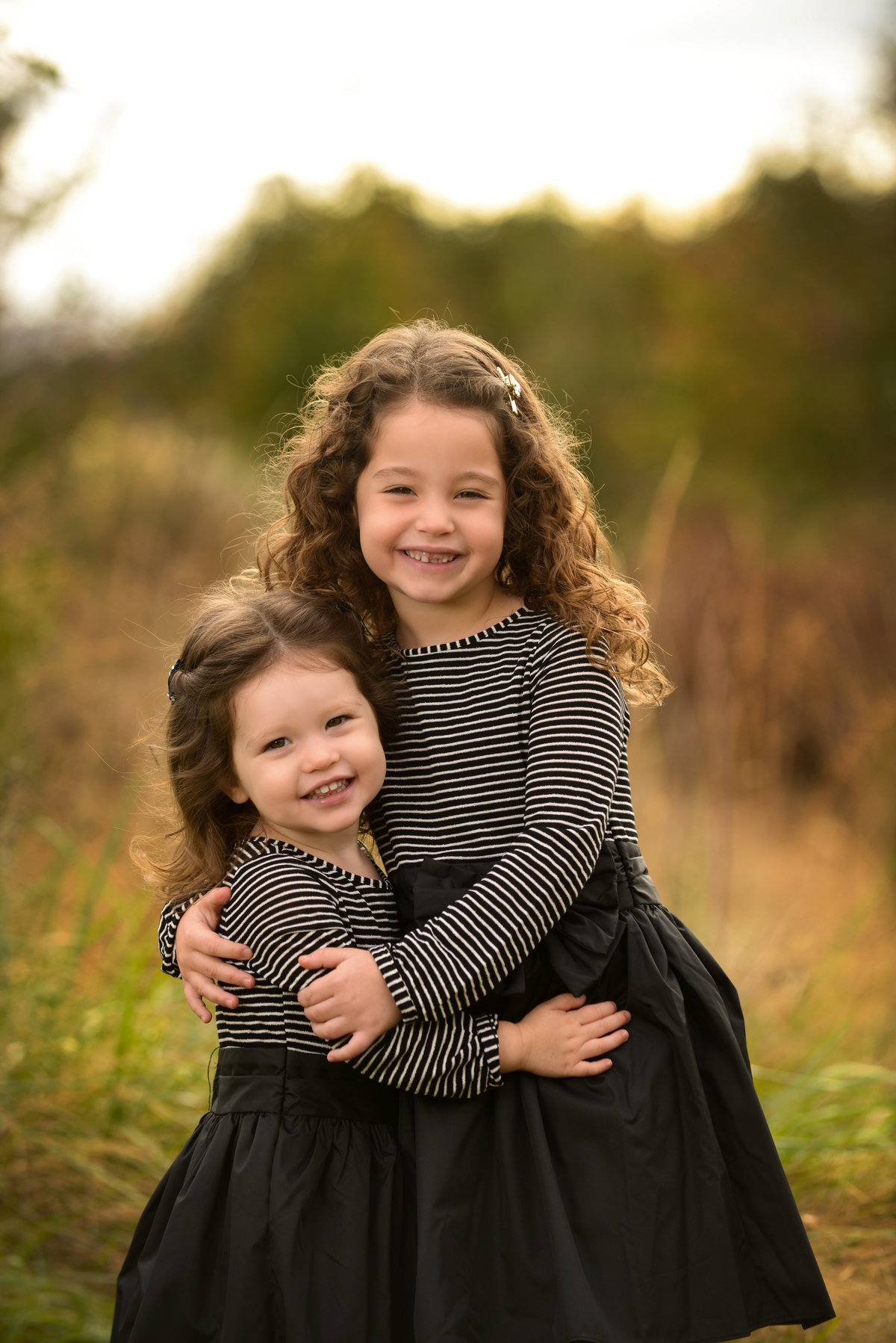 Sweet sisters during their family photo shoot in Baltimore, MD