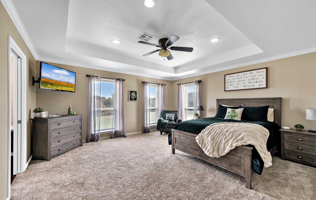Bedroom with comfortable bedding and smart TV in this four-bedroom, four-bathroom vacation rental home and guest house with free WiFi, fully equipped kitchen, firepit and room for 10 in Waco, TX.