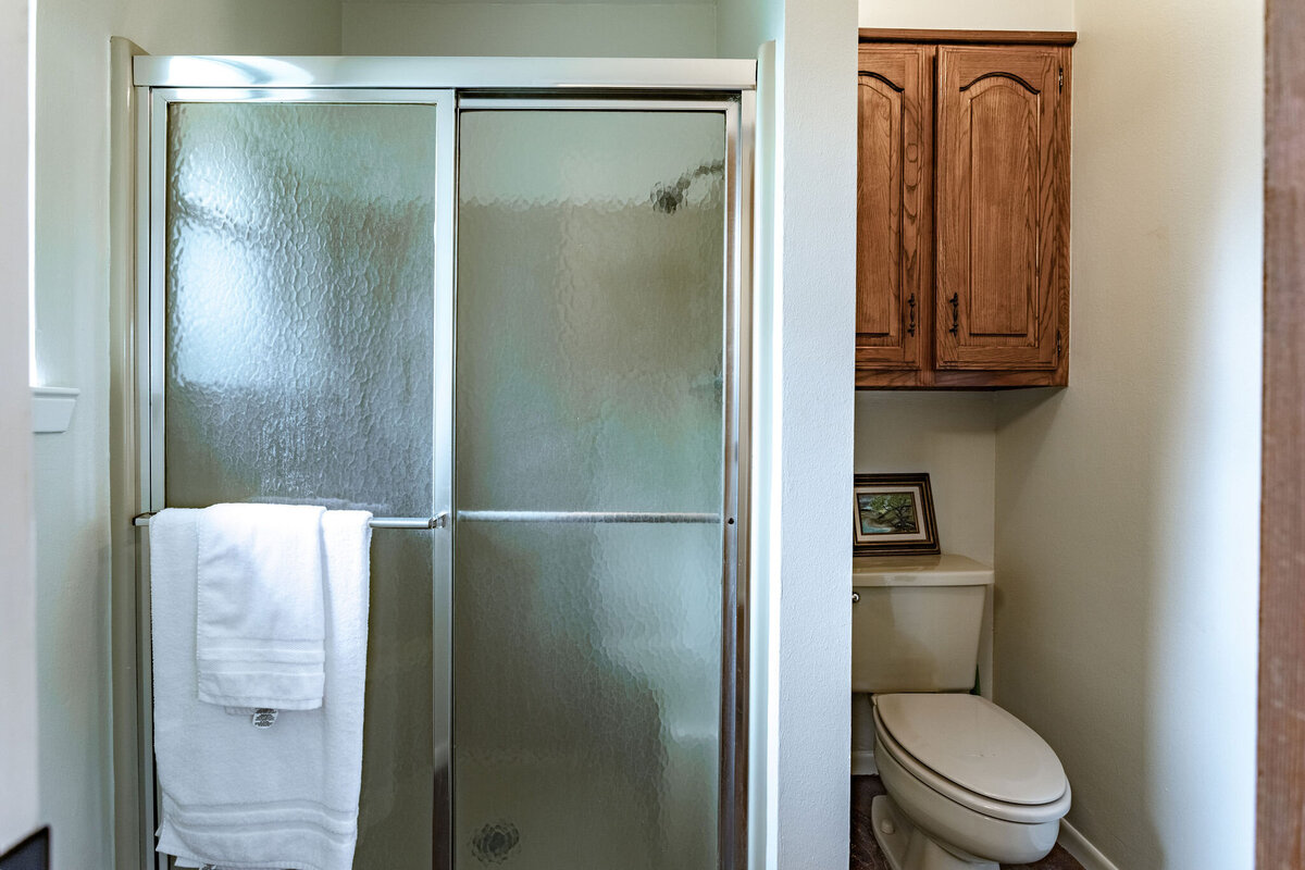 Shower with glass doors in this three-bedroom, two-bathroom ranch house for 7 with incredible hiking, wildlife and views.