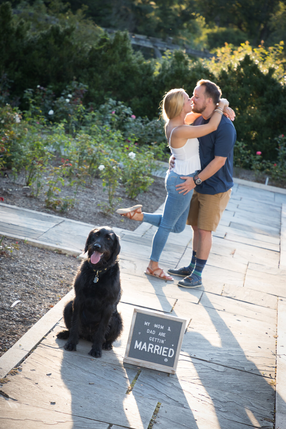 engaged-couple-kissing-beside-dog-nj