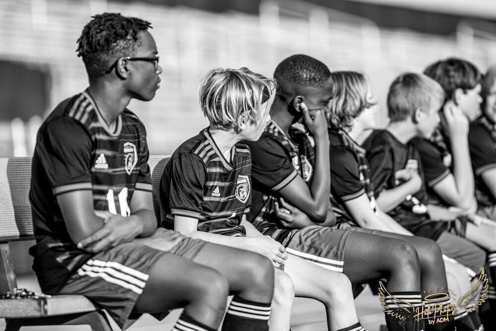 soccer team sitting on bench