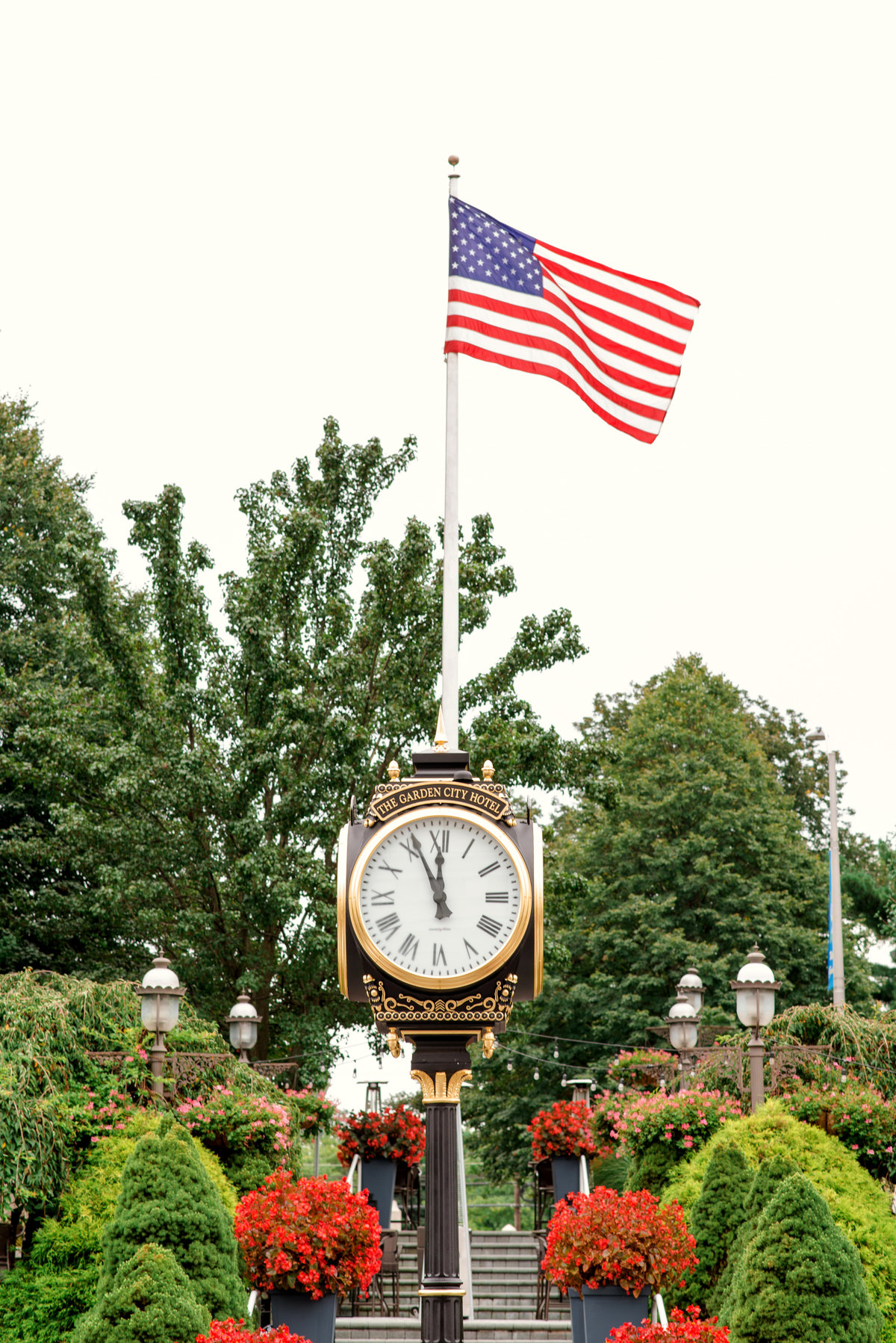 photo of the clock and American flag from outdoors at The Garden City Hotel