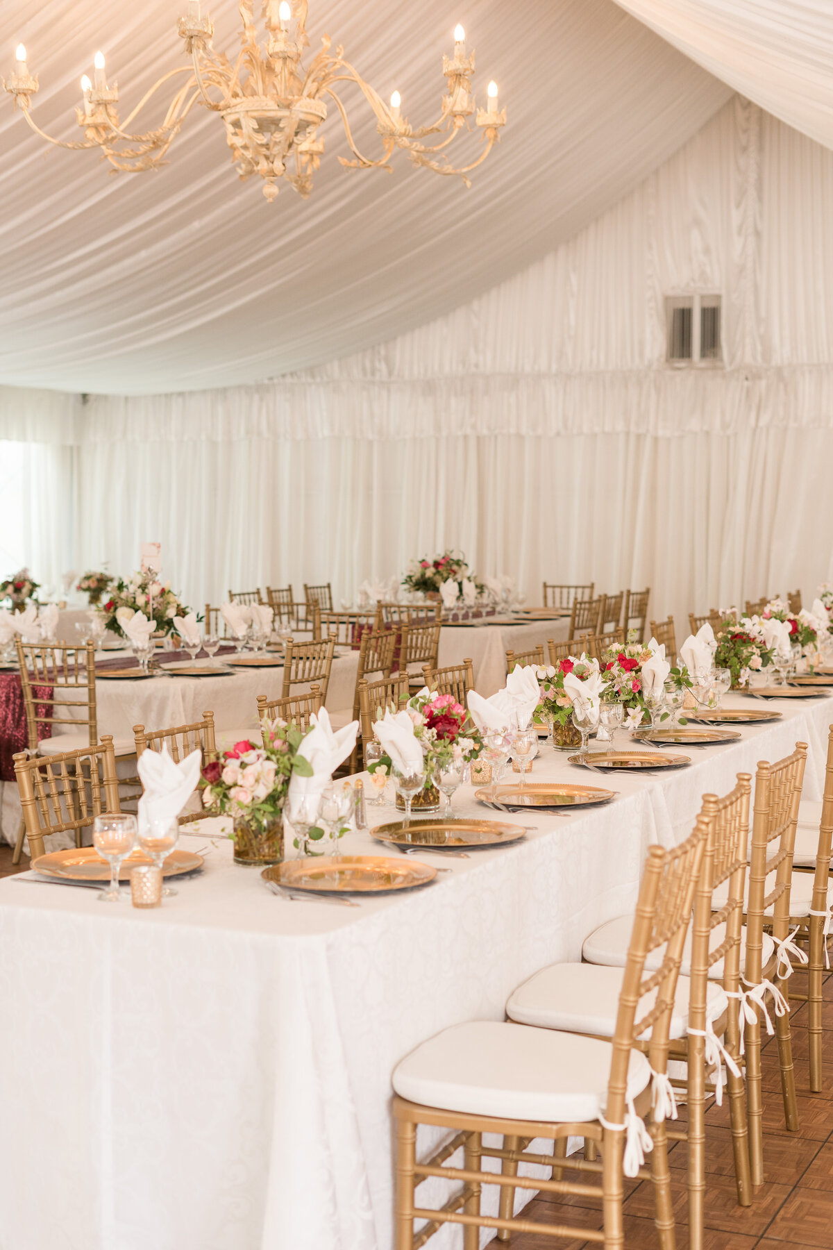 wedding reception with gold and white chiavari chairs