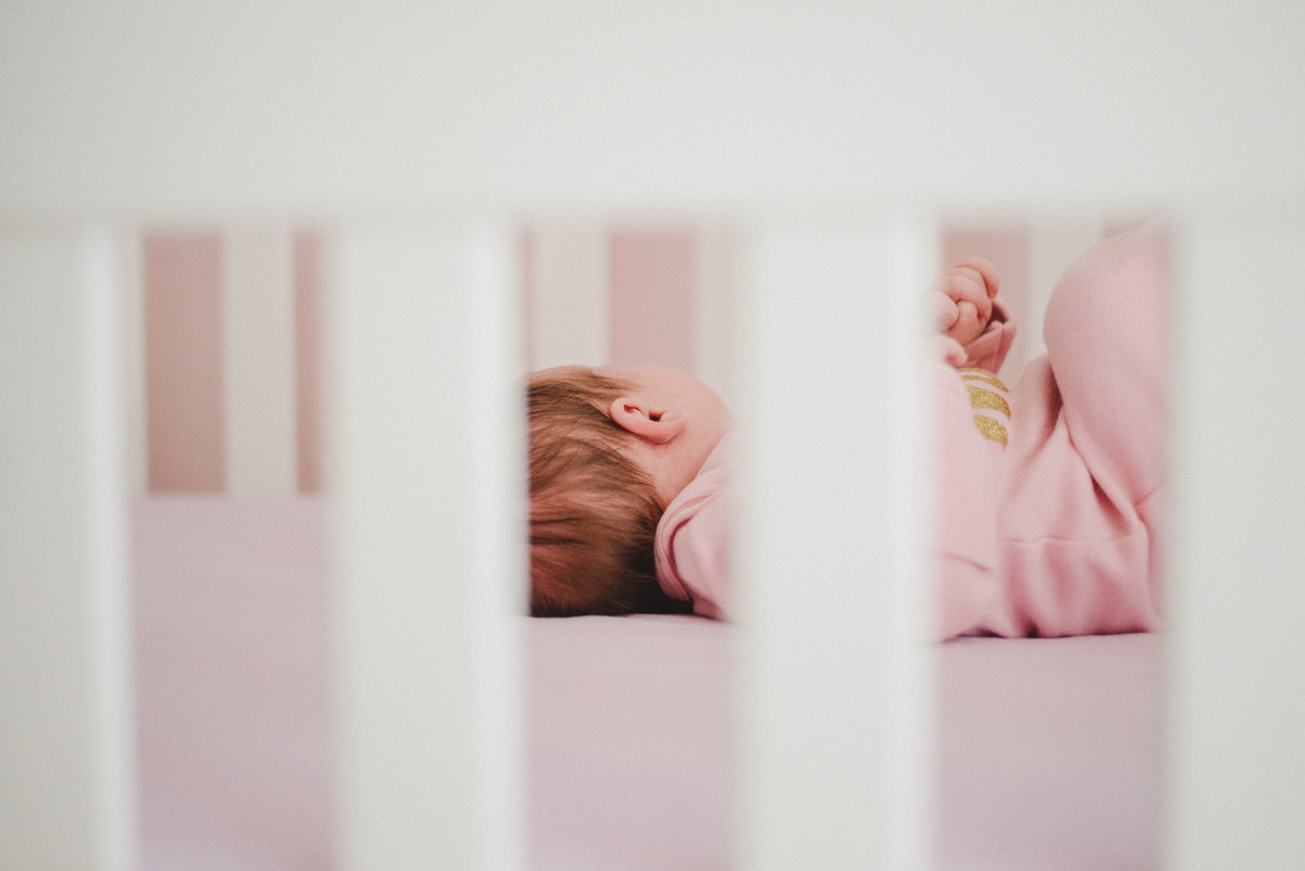 newborn baby girl in crib