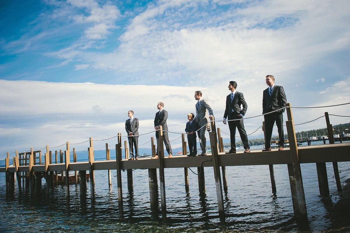 groom and groomsmen posing on a pier in Lake tahoe