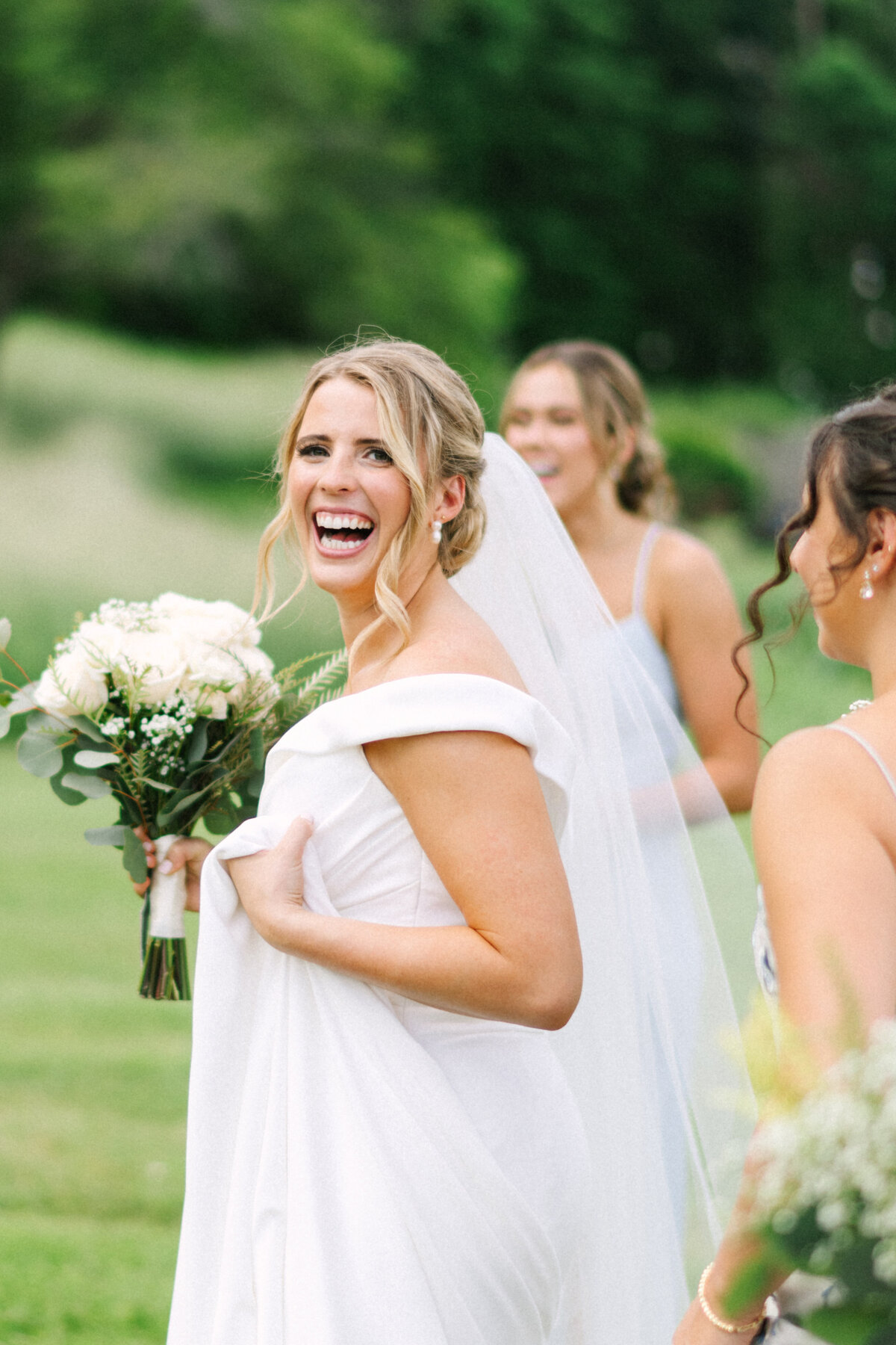 bride excitedly gets ready for pictures with her bridesmaids